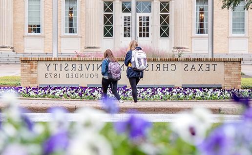 Students walking in front of TCU library